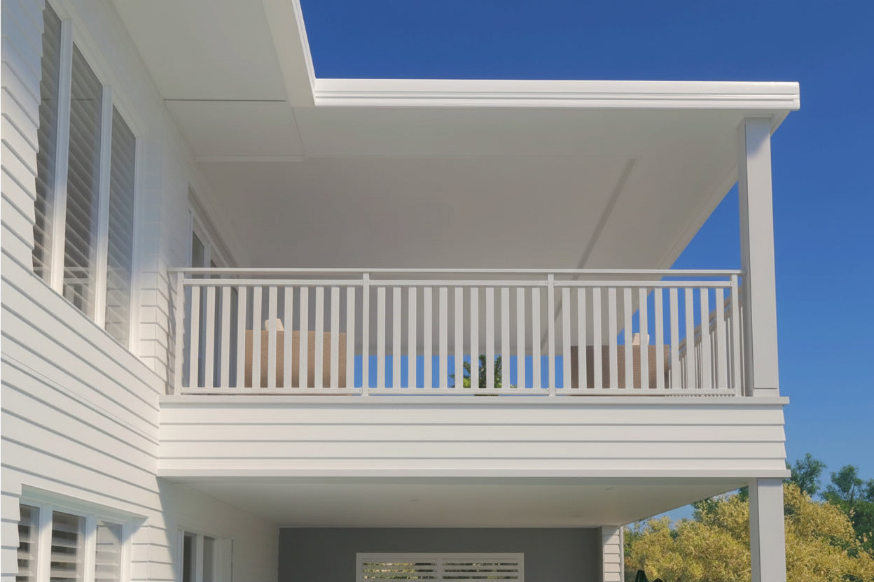 Balcony of a house with white railings and blue sky